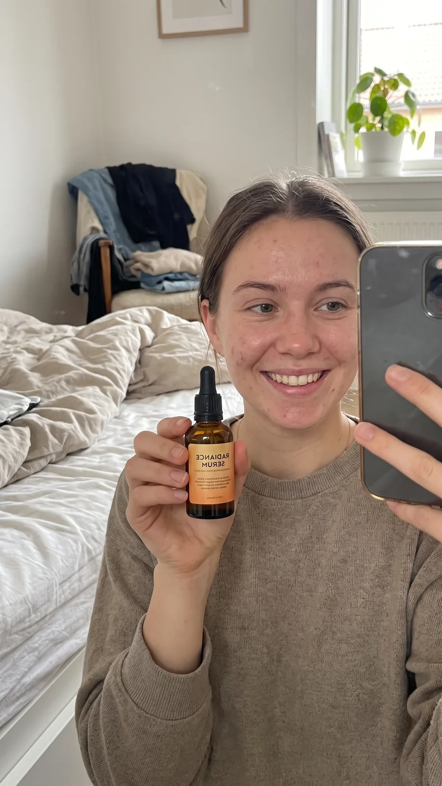 Customer-style ad still of a woman holding a serum to camera