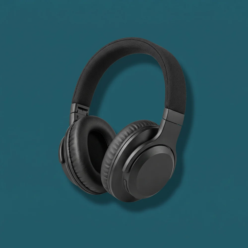 Black headphones photographed against a deep teal background